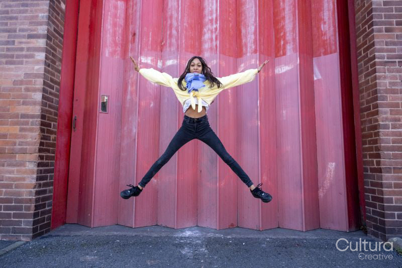 South Yorkshire, Woman jumping against pink gate