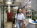 Woman walking in office hallway