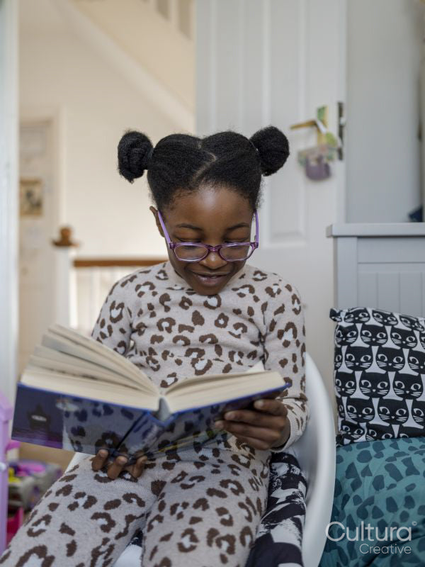 Girl reading book at home
