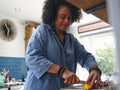 Woman chopping vegetables in kitchen