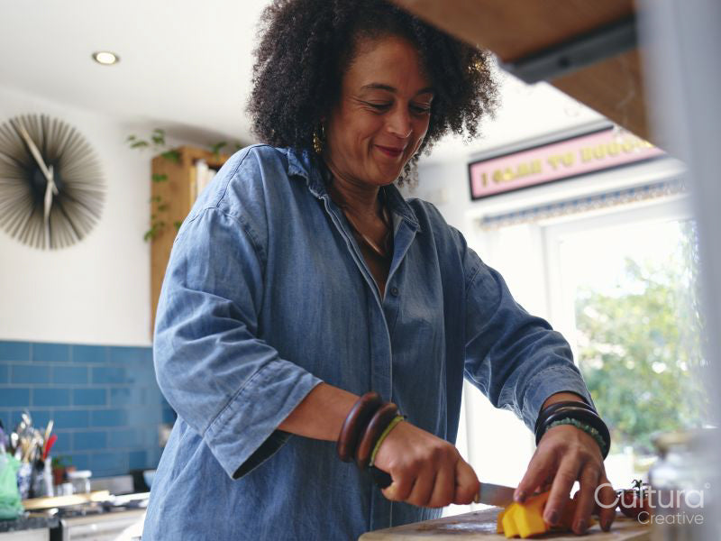 Woman chopping vegetables in kitchen