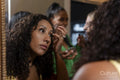 Women applying makeup before going to party