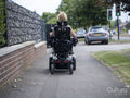 Woman in electric wheelchair going on walk