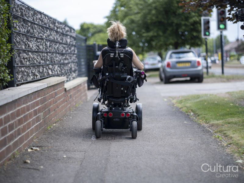 Woman in electric wheelchair going on walk