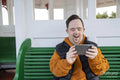 Man sitting on bench and using smart phone
