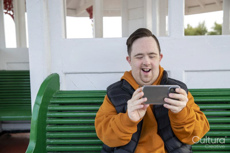 Man sitting on bench and using smart phone
