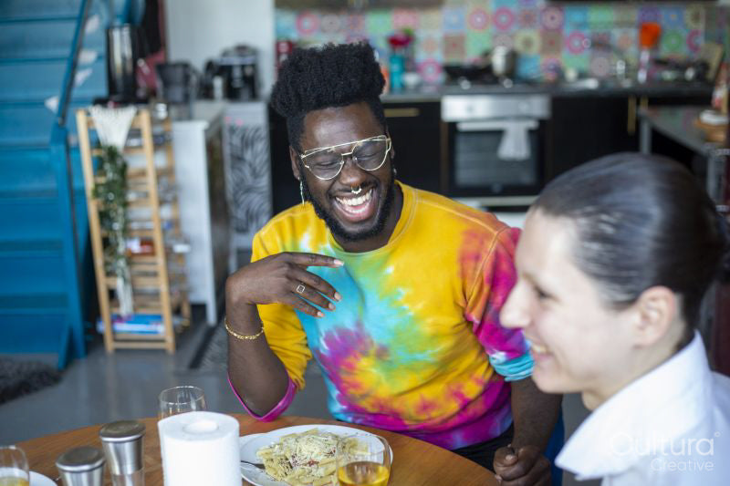 People laughing during meal at home