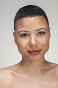 Studio portrait of smiling shirtless woman