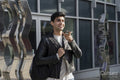 Smiling male student using phone