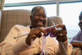 Smiling senior woman knitting in nursing home