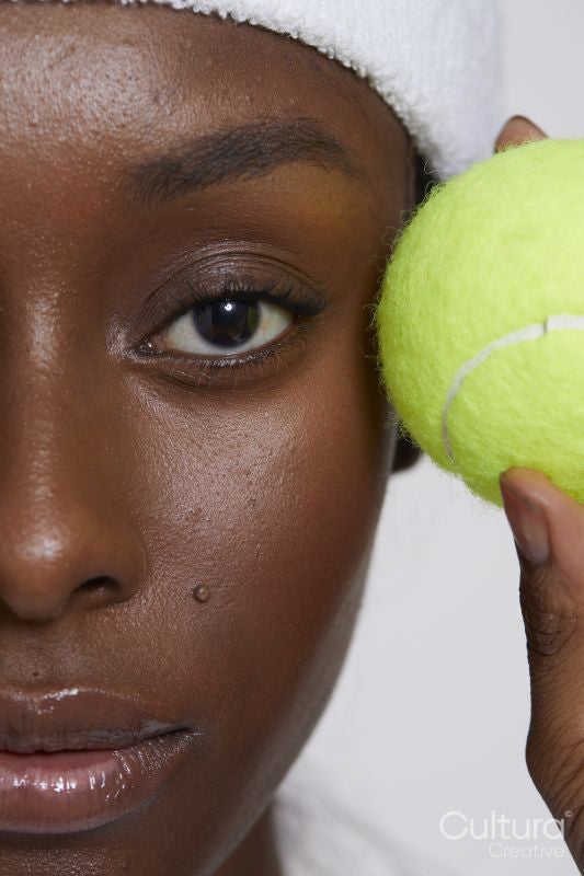 Close-up of woman with tennis ball