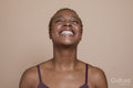 Studio portrait of smiling woman with eyes closed