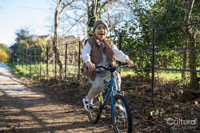 Boy riding bike in countryside