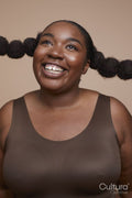 Studio shot of smiling young woman with braided hair