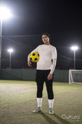 Portrait of female soccer player holding ball