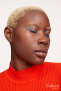 Portrait of woman with short white hair, eyes closed