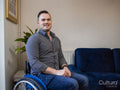 Portrait of smiling man on wheelchair at home