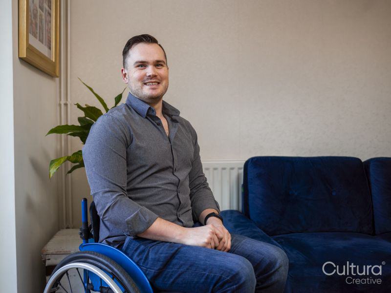 Portrait of smiling man on wheelchair at home
