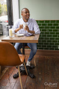 Man enjoying coffee at cafe table
