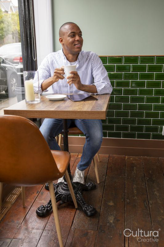 Man enjoying coffee at cafe table