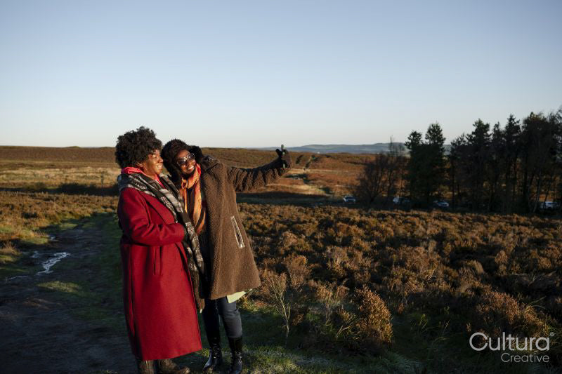Two senior women taking selfie in moorland