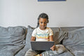 Girl using laptop on sofa