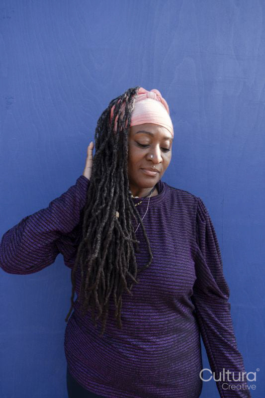 Portrait of beautiful woman with dreadlocks wearing a headscarf