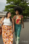 Two young women walking by river