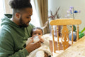 Father feeding baby daughter at home
