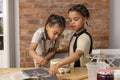 Brothers making cake in kitchen