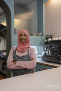 Portrait of young woman in hijab working in cafe