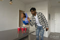 Friends playing beer pong at home party