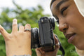Close-up of young woman wearing hijab photographing with digital camera
