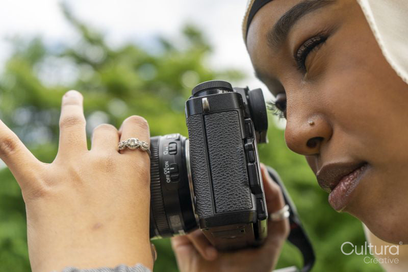 Close-up of young woman wearing hijab photographing with digital camera