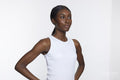Studio portrait of athletic woman in white top
