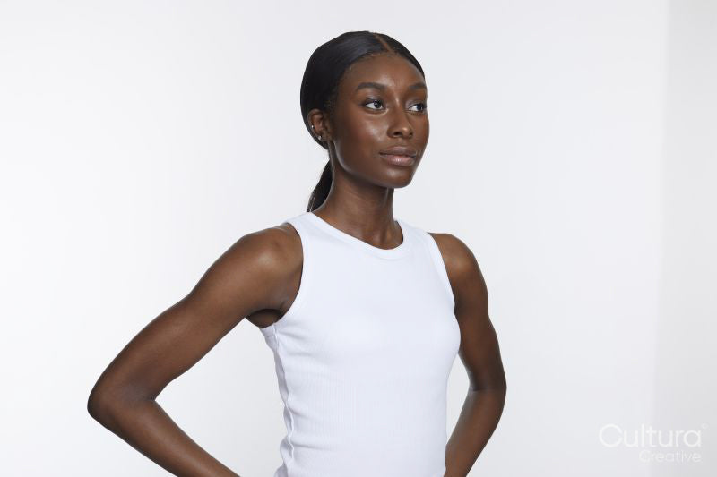 Studio portrait of athletic woman in white top