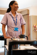 Female employee pushing cart at nursing home