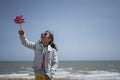 Girl playing with pinwheel on beach