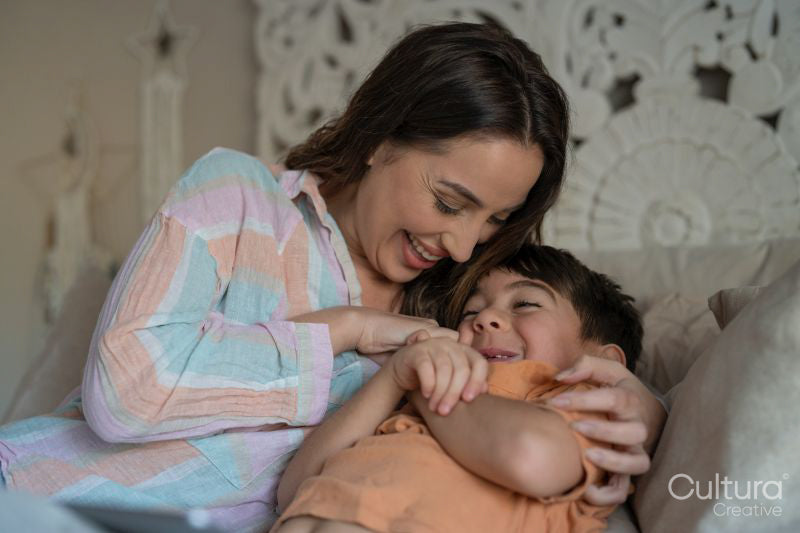 Mother and son cuddling in bedroom