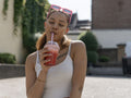 Portrait of young woman drinking smoothie