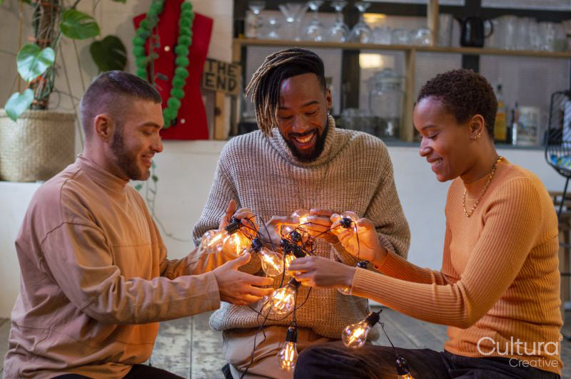 Friends untangling string light
