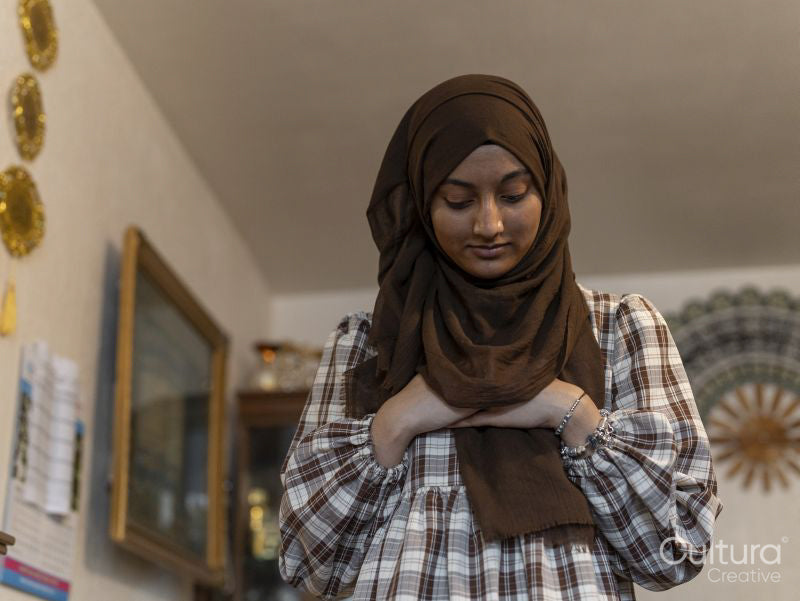 Woman praying during Ramadan celebration at home