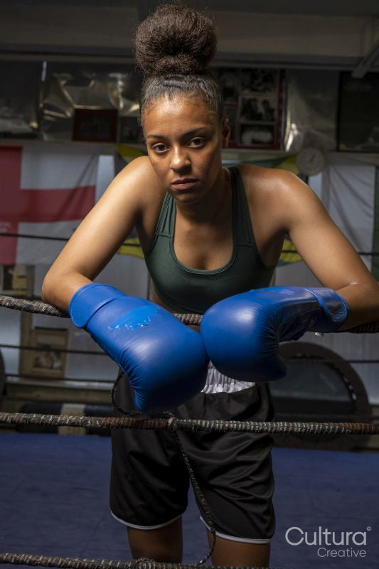 Portrait of young woman in boxing ring