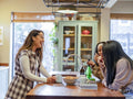 Female friends talking in kitchen