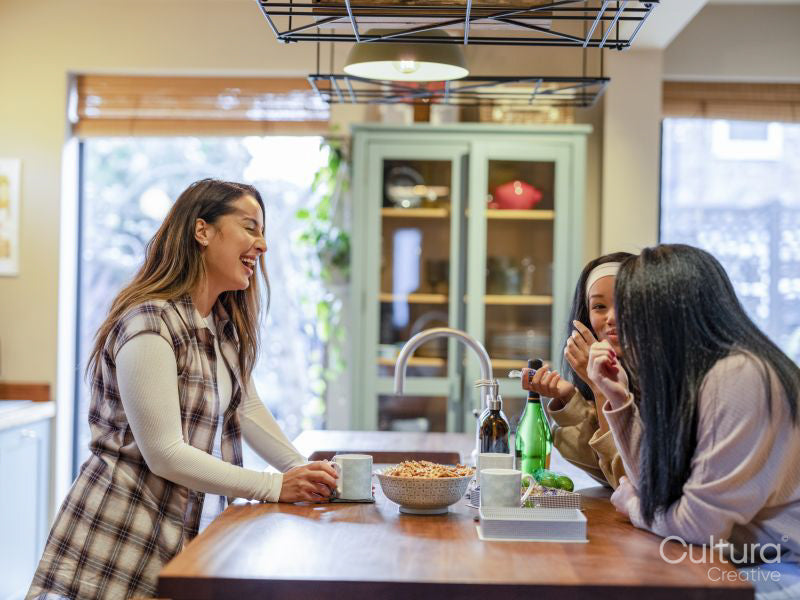 Female friends talking in kitchen
