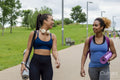 Female friends walking with yoga mats