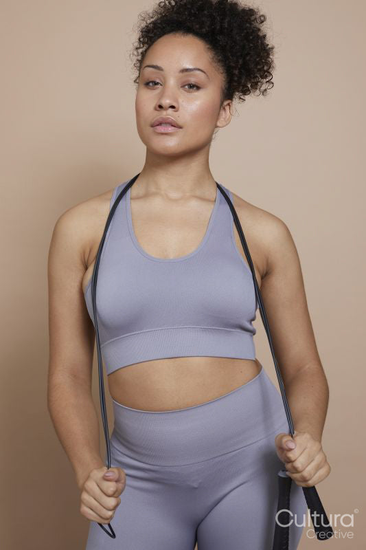 Studio portrait of athletic woman with jump rope