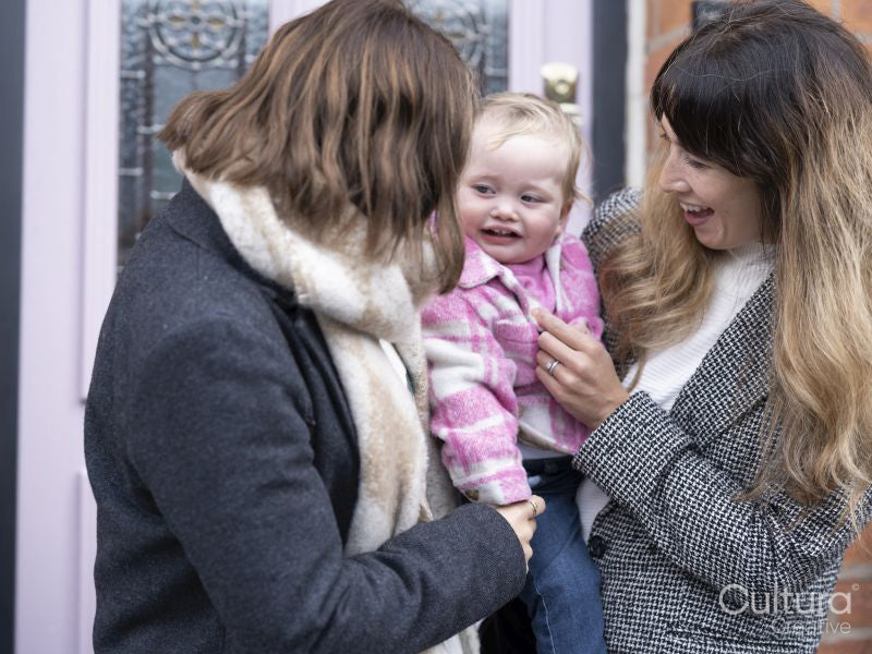 Women holding and looking at baby