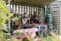 Smiling couple relaxing in urban garden