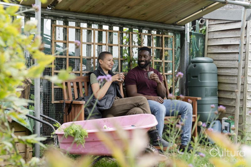 Smiling couple relaxing in urban garden